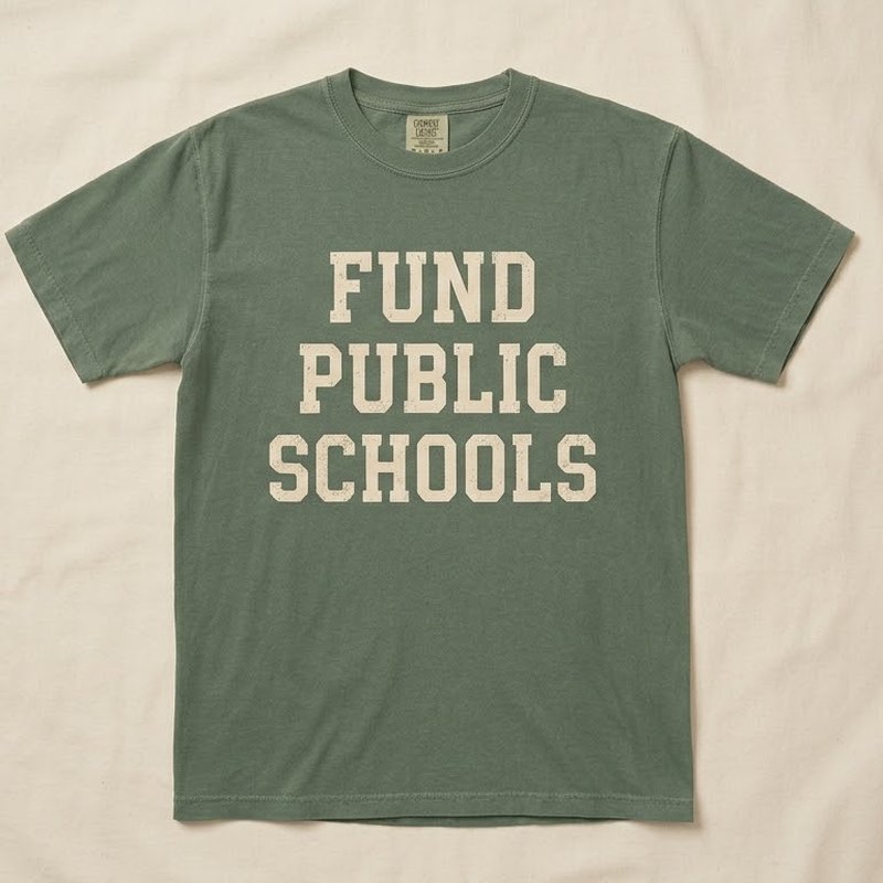 Sage green t-shirt reading Fund Public Schools in cream varsity letters